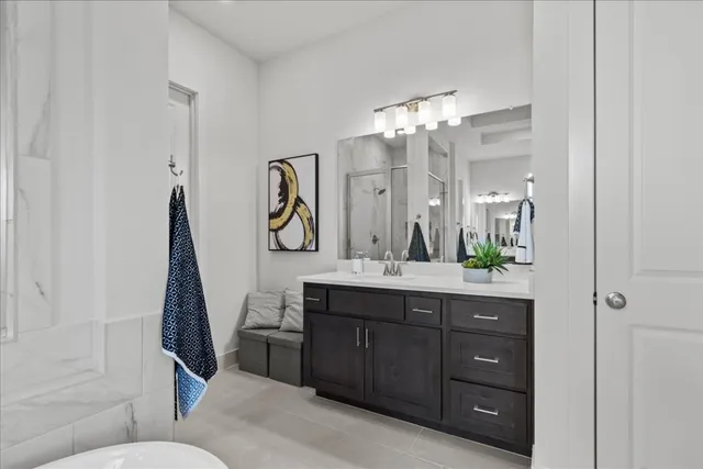a en suite bathroom with a double vanity sink and a mirror