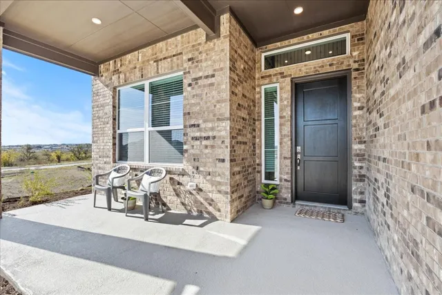 a view of balcony with furniture and floor to ceiling window
