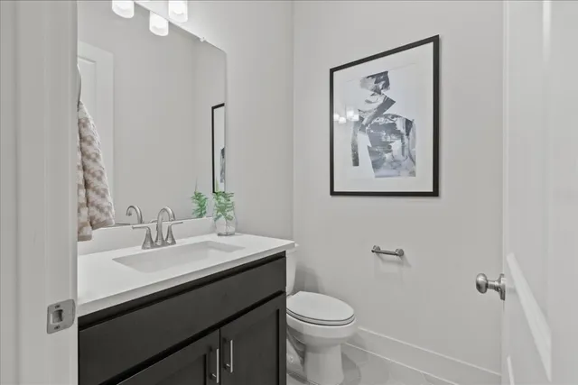 a bathroom with a sink vanity and toilet