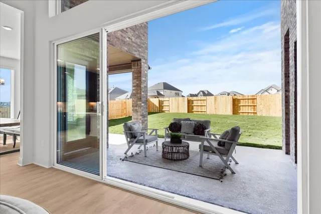 a dining room with furniture and a floor to ceiling window
