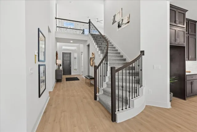 a view of a hallway with wooden floor and entryway