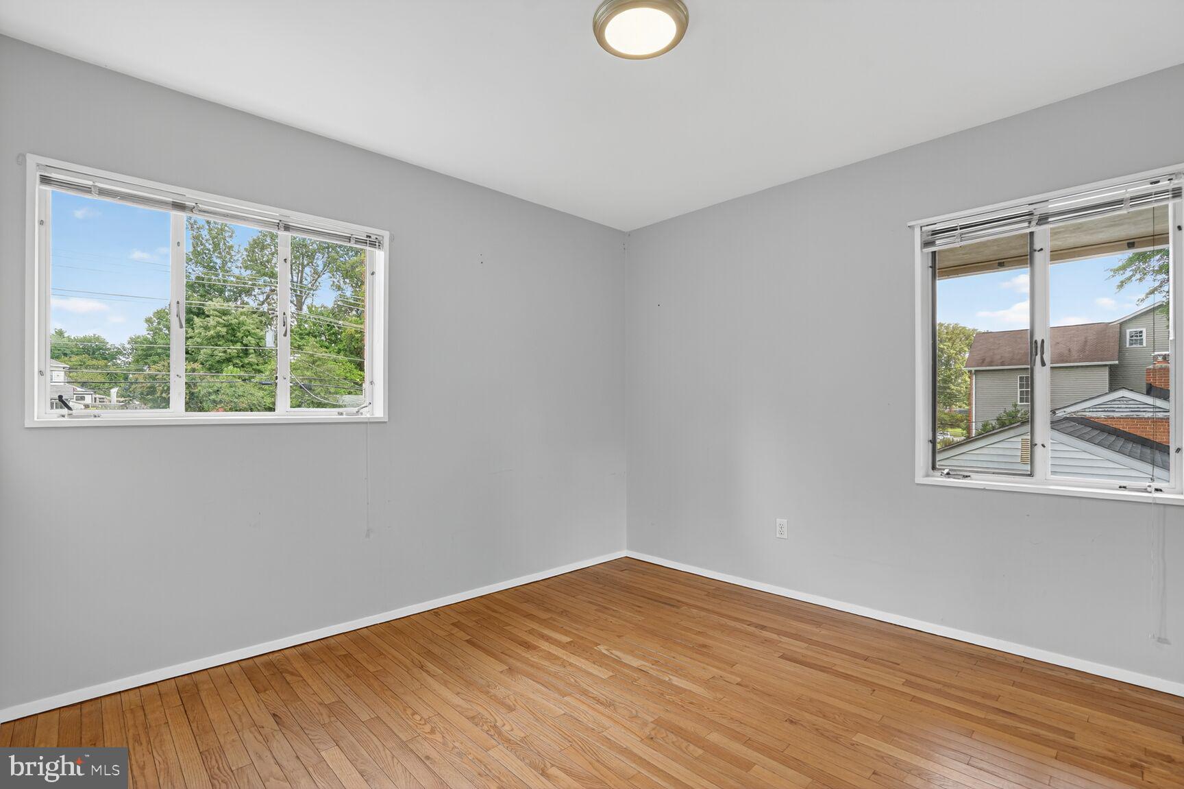 7319 Leesville Boulevard Springfield, VA 22151 - Photo 11 of 18 a view of an empty room with wooden floor and a window