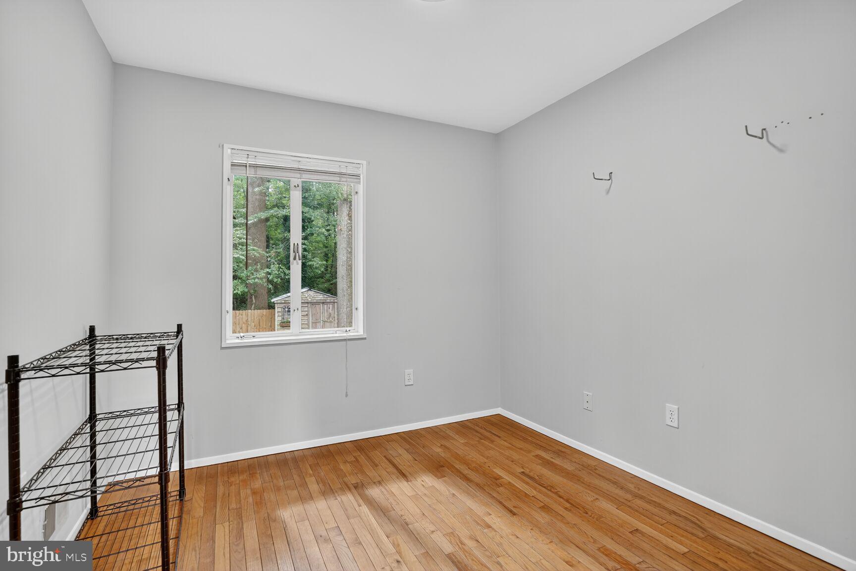7319 Leesville Boulevard Springfield, VA 22151 - Photo 13 of 18 a view of an empty room with wooden floor and a window