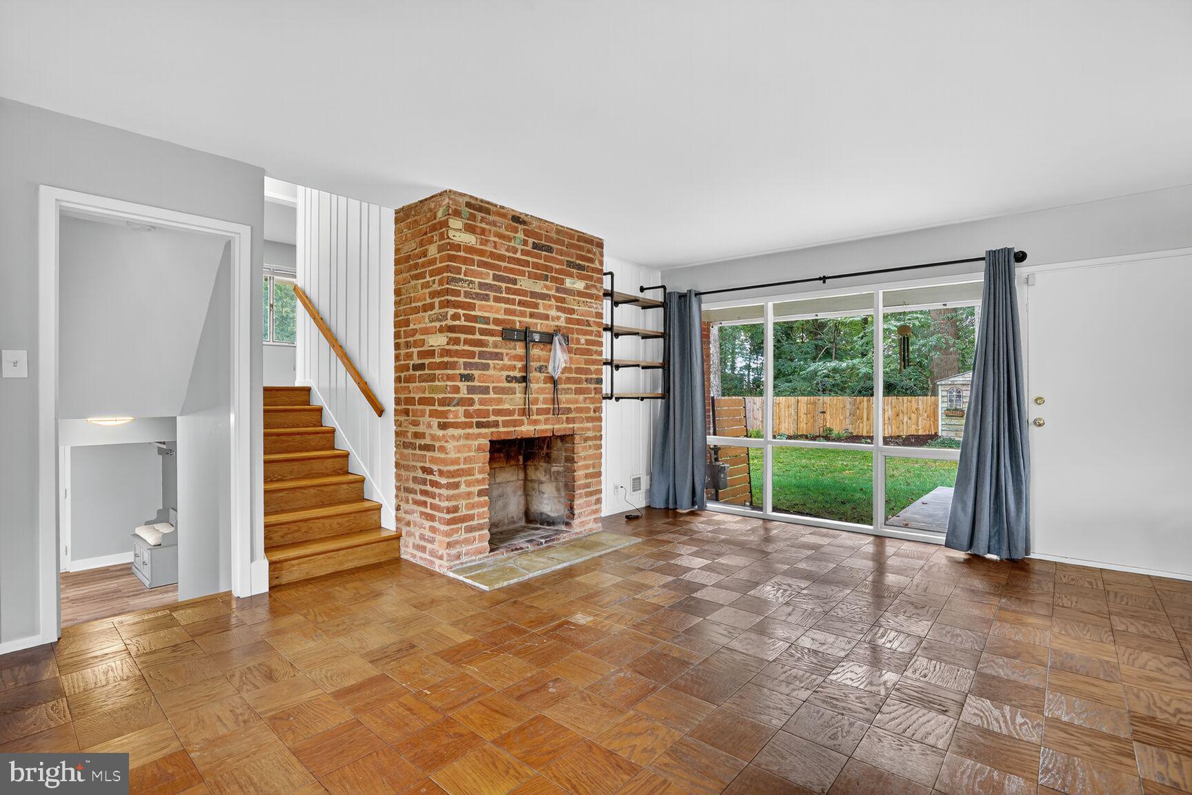 7319 Leesville Boulevard Springfield, VA 22151 - Photo 7 of 18 a view of an empty room with a fireplace and a window
