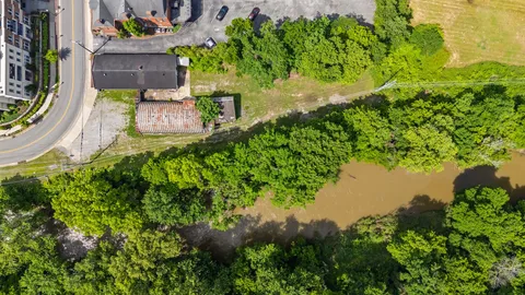 an aerial view of a house with a yard and lake view