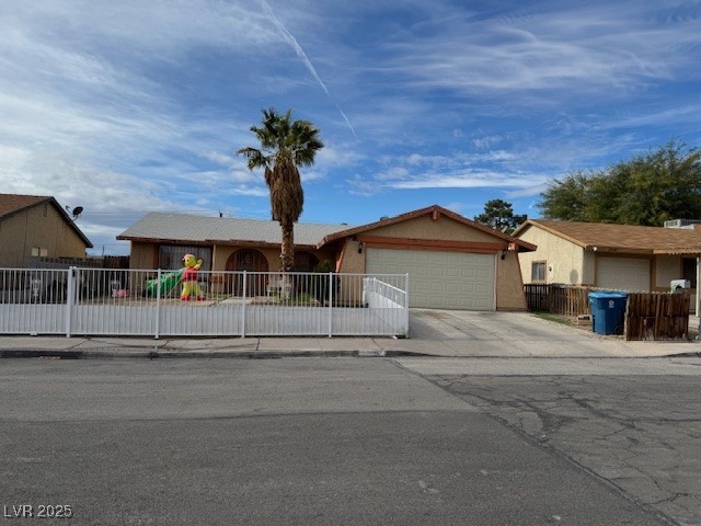 3631 Briarcliff Road Las Vegas, NV 89115 - Photo 11 of 15 Single story home with a fenced front yard, concrete driveway, an attached garage, and stucco siding