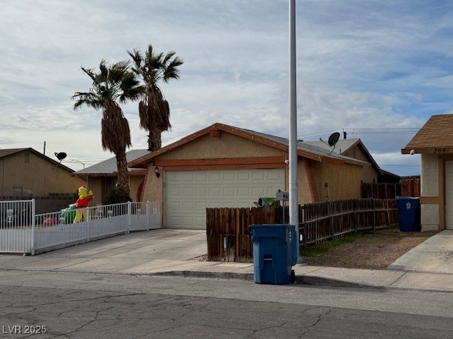 3631 Briarcliff Road Las Vegas, NV 89115 - Photo 13 of 15 Ranch-style house featuring stucco siding, concrete driveway, and a garage