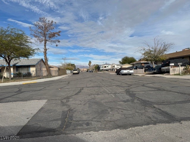 3631 Briarcliff Road Las Vegas, NV 89115 - Photo 5 of 15 View of asphalt road featuring sidewalks, a residential view, and curbs