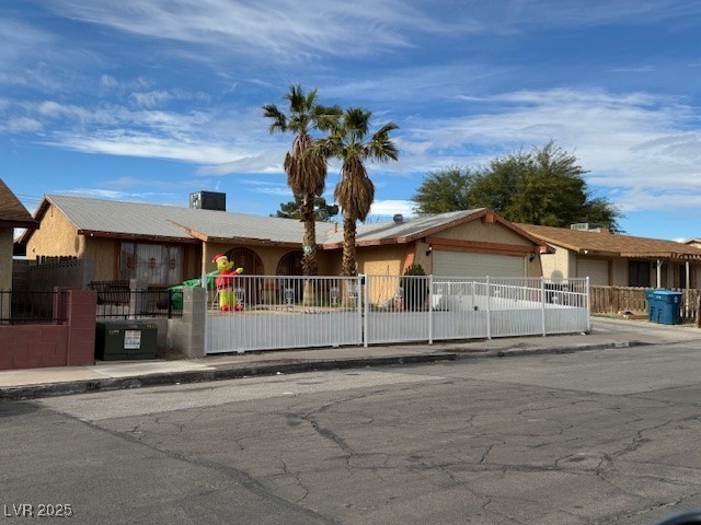 3631 Briarcliff Road Las Vegas, NV 89115 - Photo 6 of 15 Single story home with a fenced front yard, an attached garage, and stucco siding