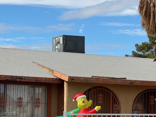 3631 Briarcliff Road Las Vegas, NV 89115 - Photo 8 of 15 Exterior view of stucco siding and a shingled roof