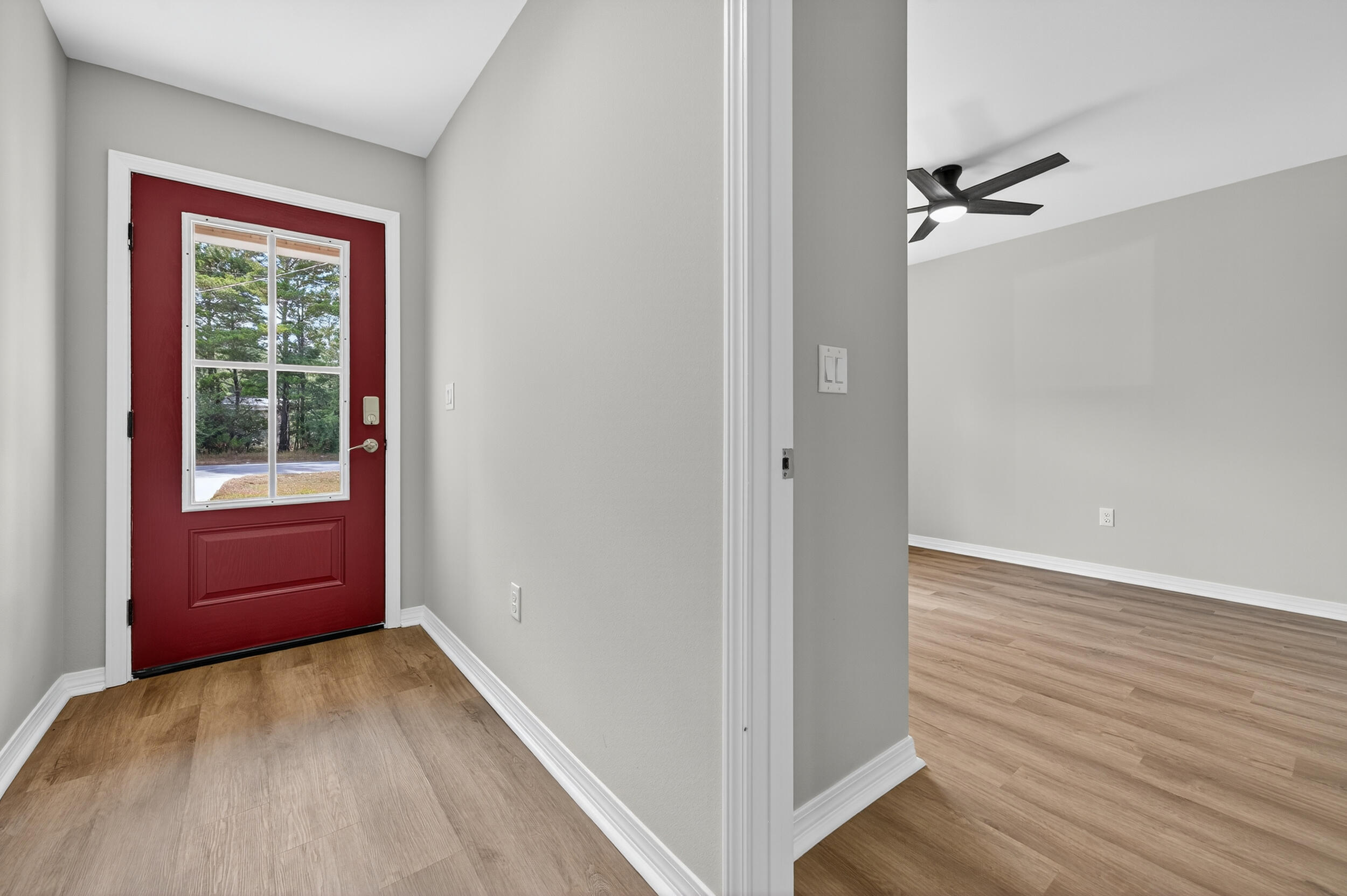 5327 B Kervin Road Crestview, FL 32539 - Photo 7 of 47 a view of hallway with a large window and wooden floor