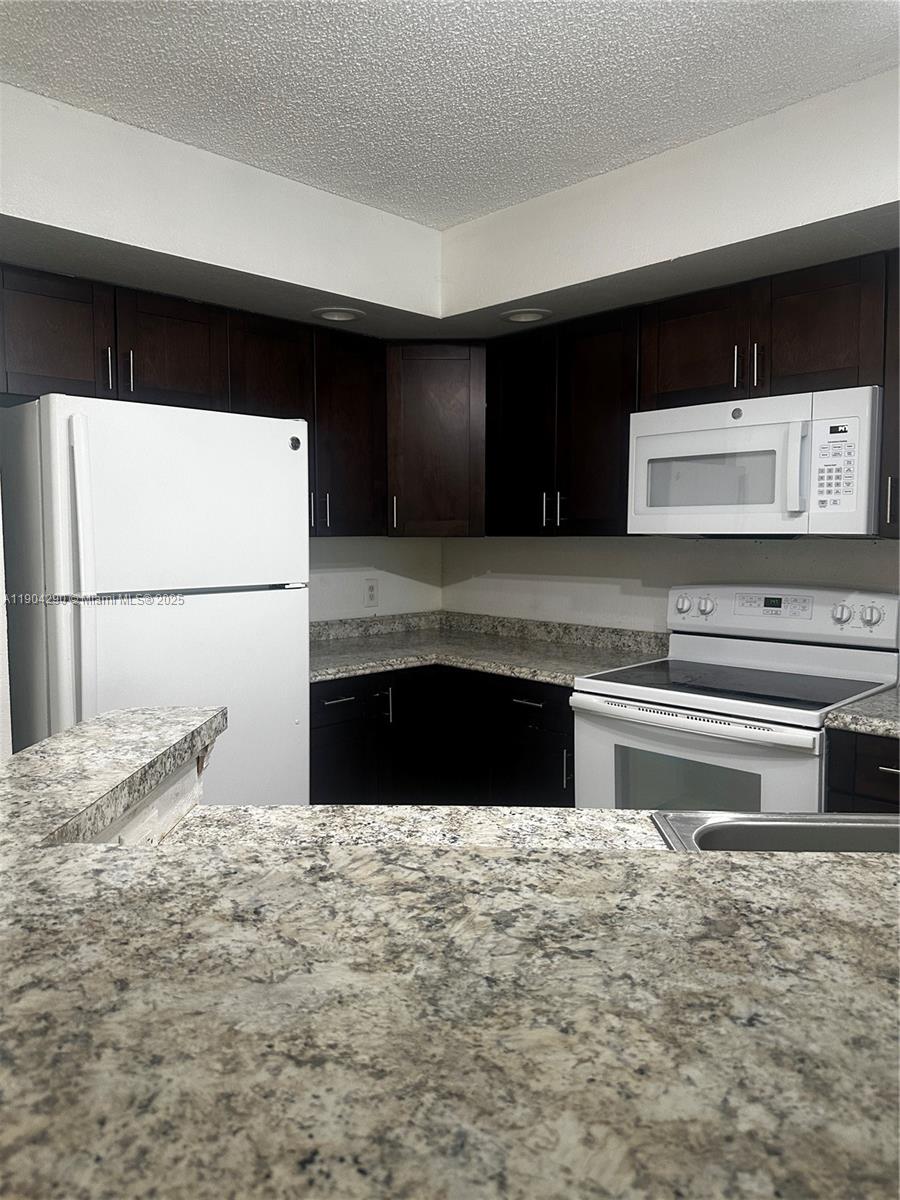 3360 Pinewalk Drive North, Unit 1325 Margate, FL 33063 - Photo 1 of 16 a kitchen with a stove and a refrigerator