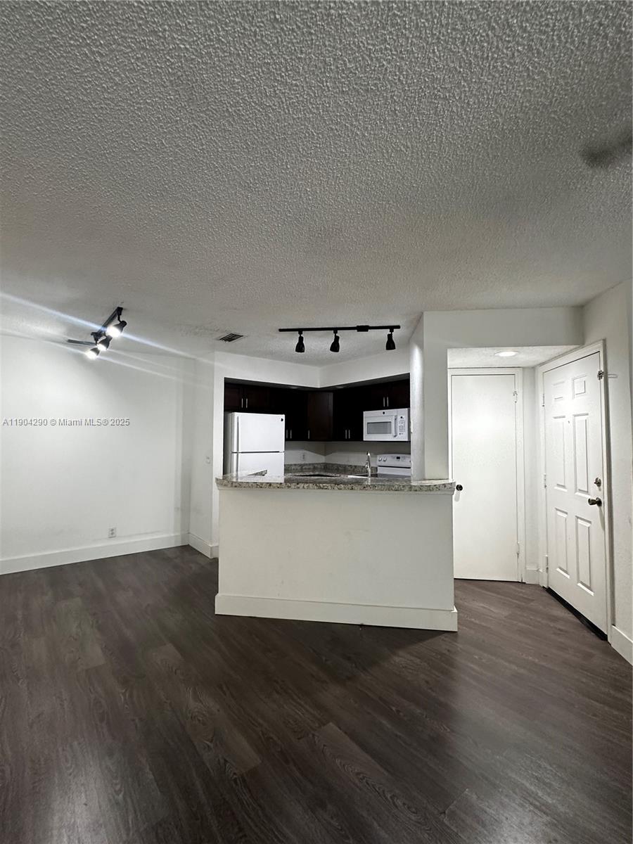 3360 Pinewalk Drive North, Unit 1325 Margate, FL 33063 - Photo 7 of 16 a living room with stainless steel appliances kitchen island a hardwood floor and a sink