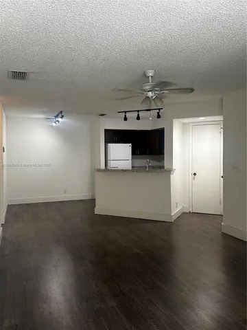 a view of a kitchen with a sink and wooden floor