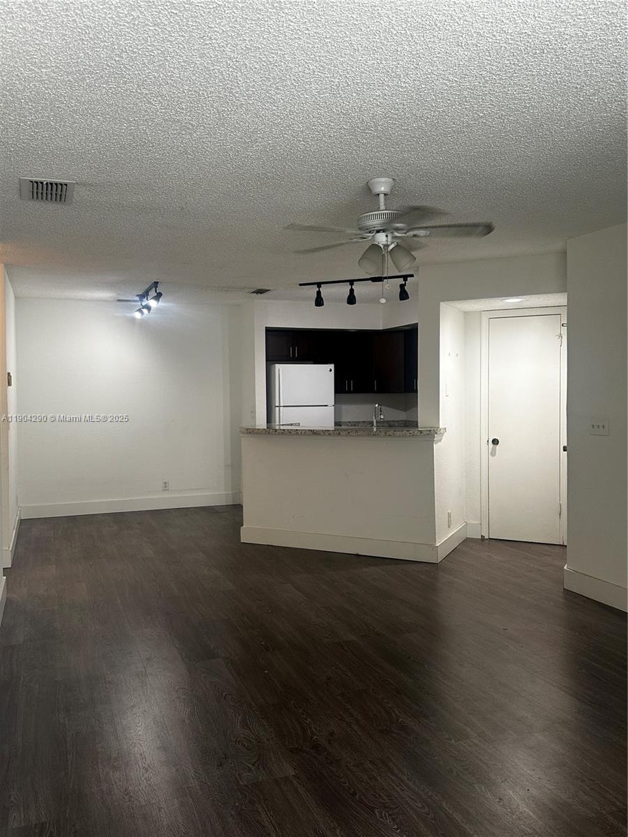 3360 Pinewalk Drive North, Unit 1325 Margate, FL 33063 - Photo 8 of 16 a view of a kitchen with a sink and wooden floor