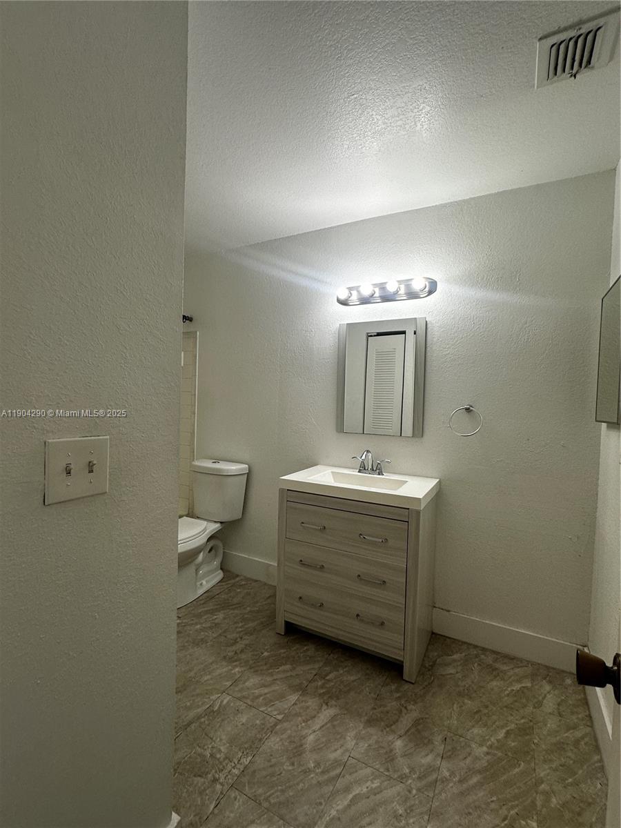 3360 Pinewalk Drive North, Unit 1325 Margate, FL 33063 - Photo 9 of 16 a bathroom with a sink double vanity and a mirror