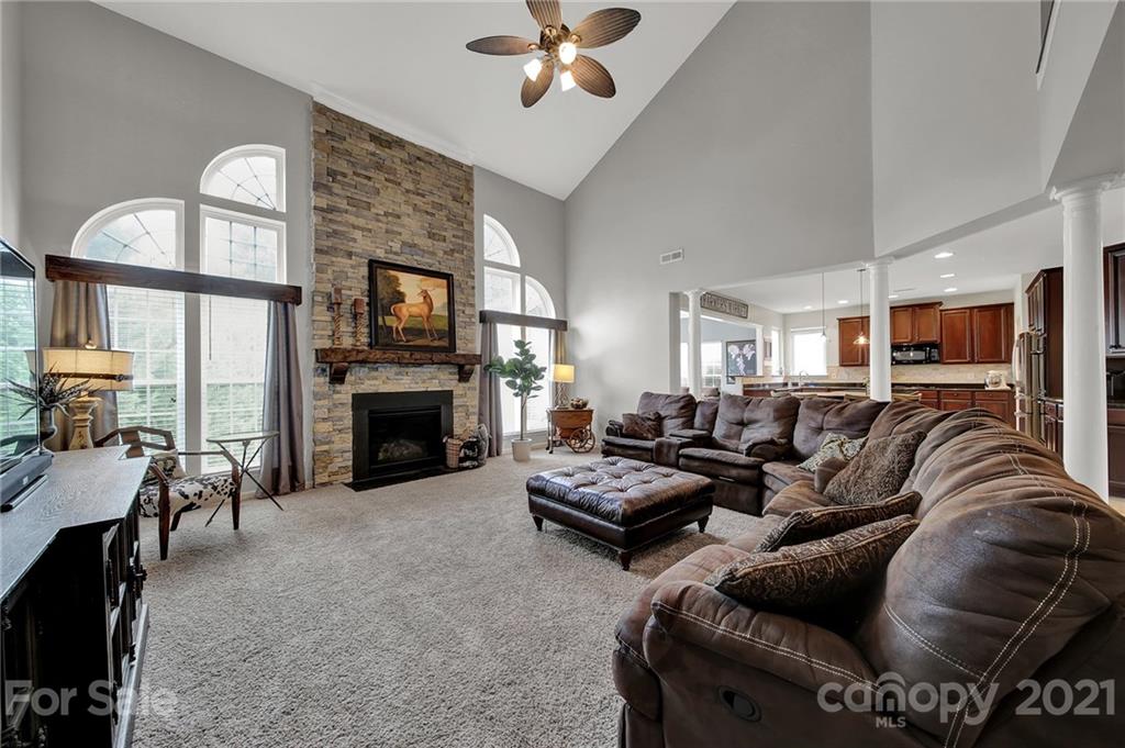 635 Panthers Way Fort Mill, SC 29708 - Photo 13 of 47 a living room with furniture kitchen view and a fireplace