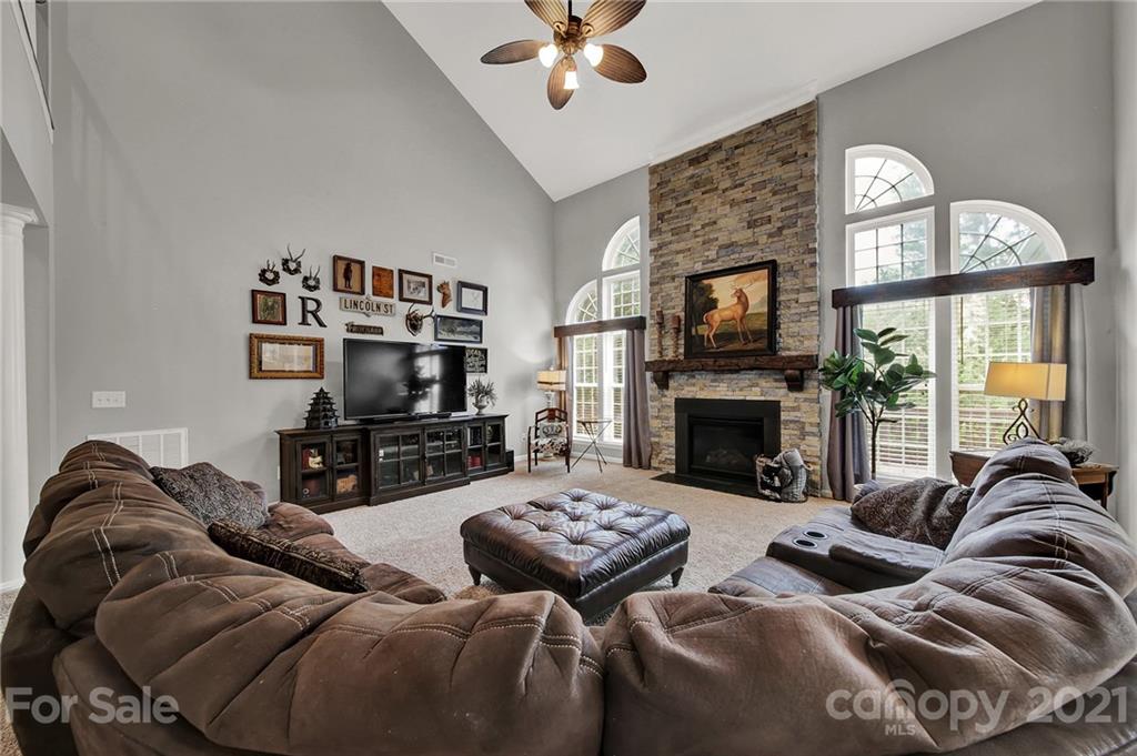 635 Panthers Way Fort Mill, SC 29708 - Photo 16 of 47 a living room with furniture a fireplace and a flat screen tv