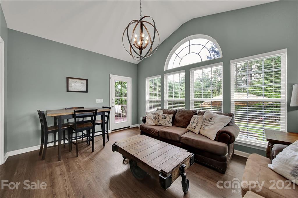 635 Panthers Way Fort Mill, SC 29708 - Photo 22 of 47 a living room with furniture a dining table and a large window