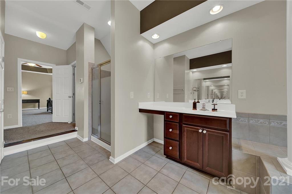 635 Panthers Way Fort Mill, SC 29708 - Photo 32 of 47 a spacious bathroom with a sink and a mirror
