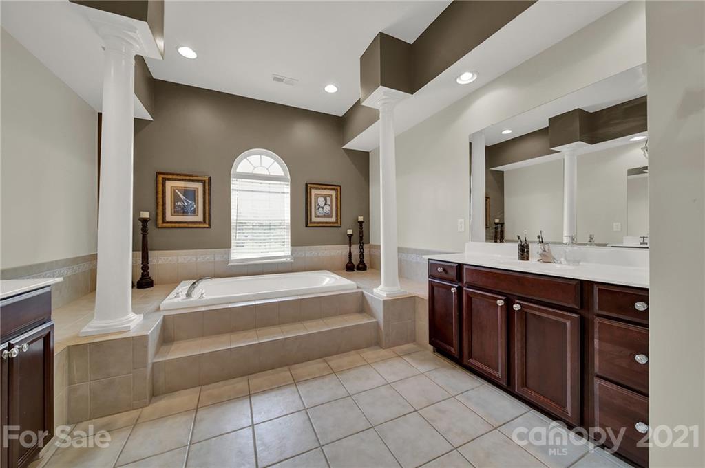 635 Panthers Way Fort Mill, SC 29708 - Photo 33 of 47 a spacious bathroom with a tub sink and mirror