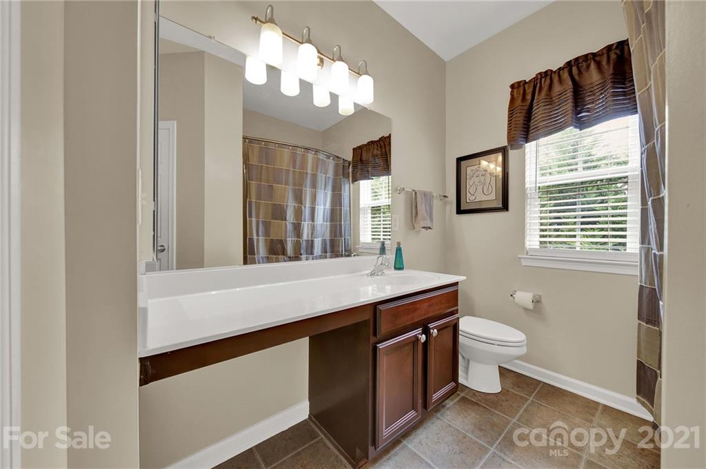 635 Panthers Way Fort Mill, SC 29708 - Photo 36 of 47 a bathroom with a sink a toilet a mirror and window