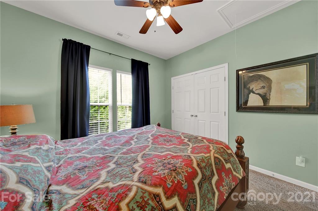 635 Panthers Way Fort Mill, SC 29708 - Photo 38 of 47 a bedroom with a large bed and a chandelier