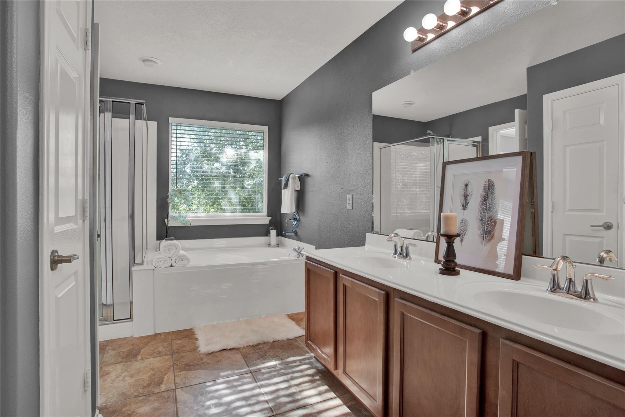 326 Brandy Ridge Lane Dickinson, TX 77539 - Photo 15 of 22 a bathroom with a double vanity sink a mirror and a bathtub