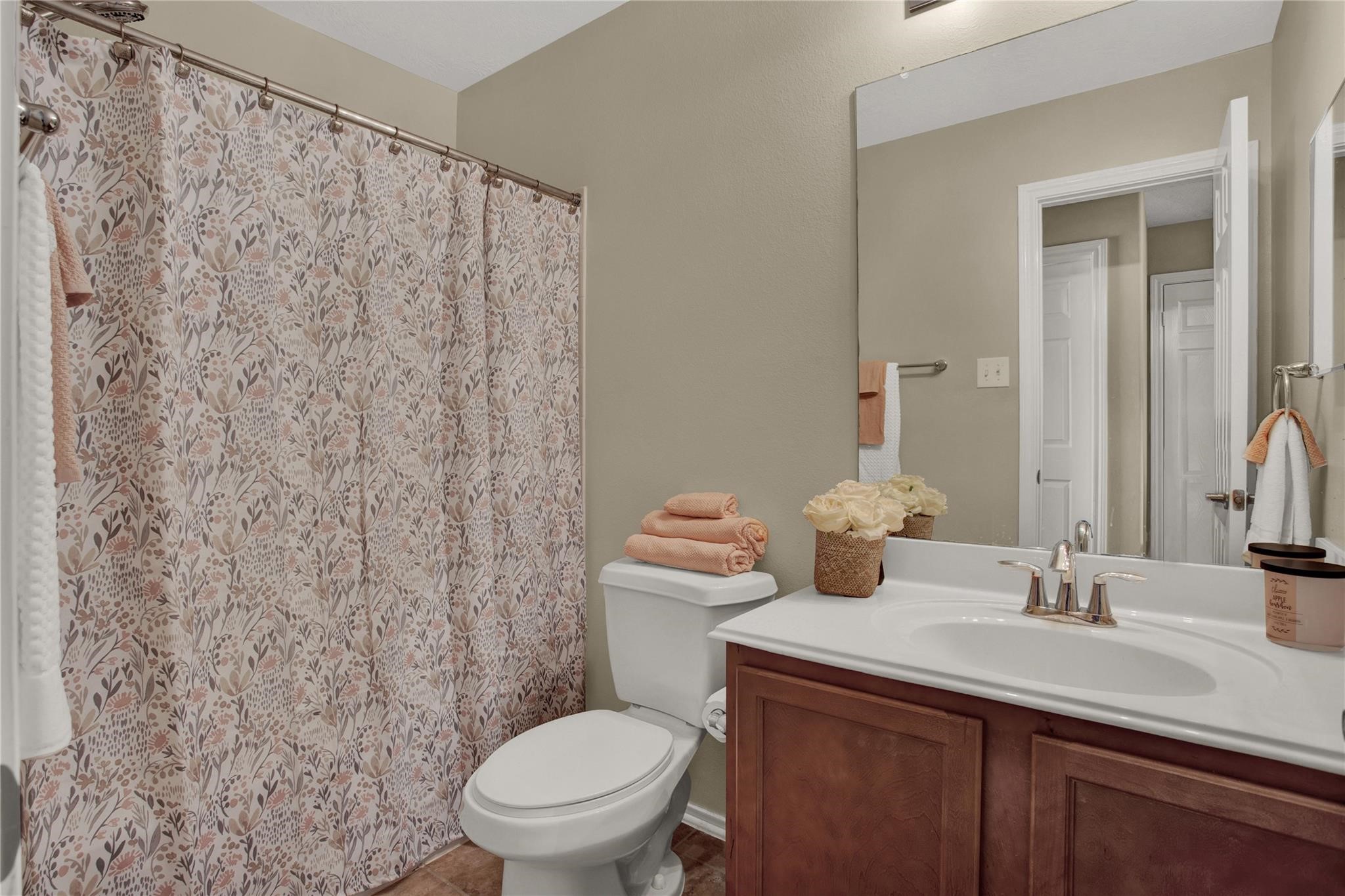 326 Brandy Ridge Lane Dickinson, TX 77539 - Photo 20 of 22 a bathroom with a granite countertop sink a toilet and a mirror
