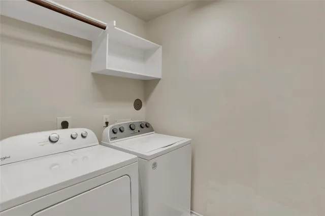 a view of storage and utility room with washer and dryer