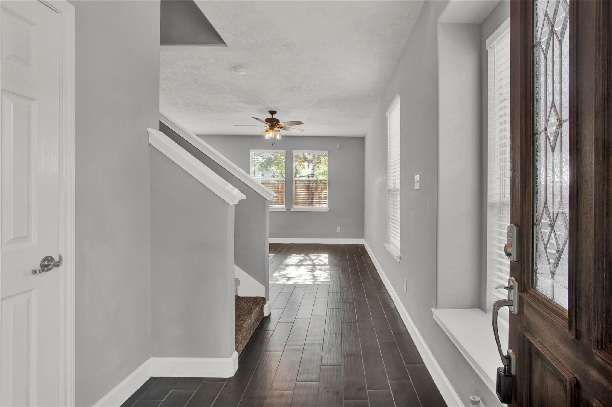 326 Brandy Ridge Lane Dickinson, TX 77539 - Photo 3 of 22 a view of a hallway with wooden floor and staircase