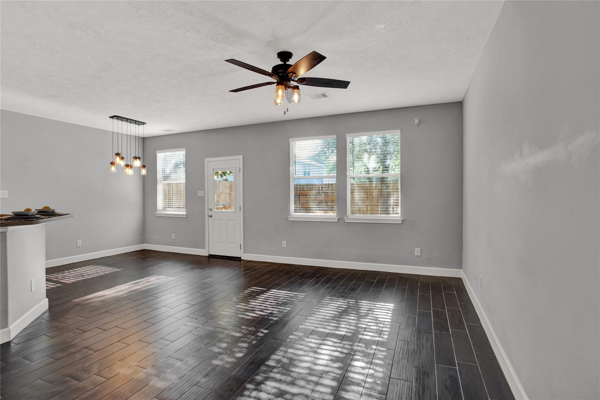 326 Brandy Ridge Lane Dickinson, TX 77539 - Photo 4 of 22 a view of an empty room with wooden floor and a window