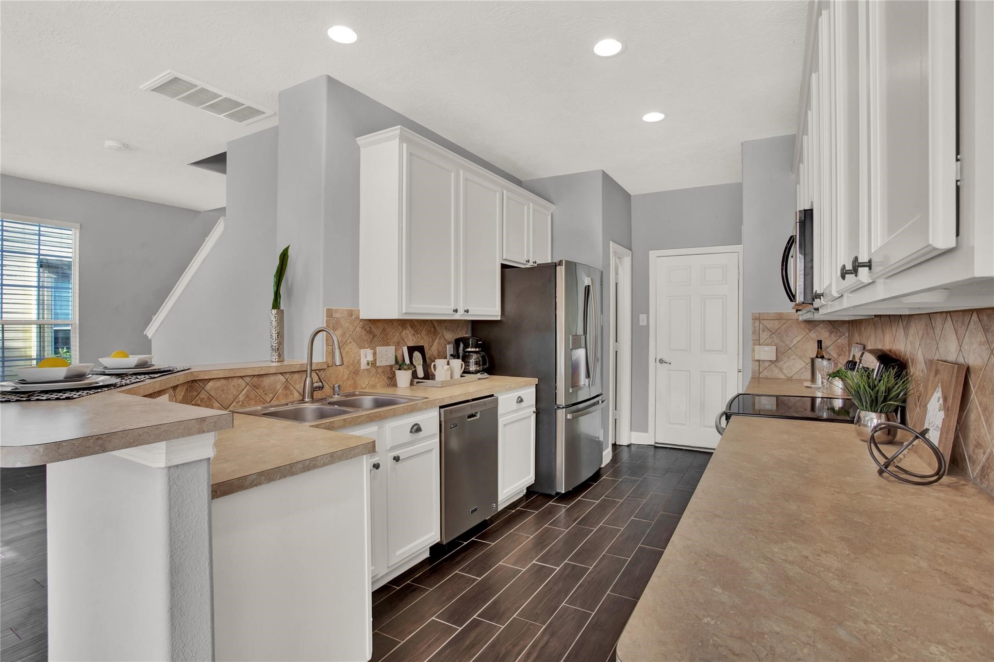 326 Brandy Ridge Lane Dickinson, TX 77539 - Photo 7 of 22 a kitchen with a sink a refrigerator and cabinets