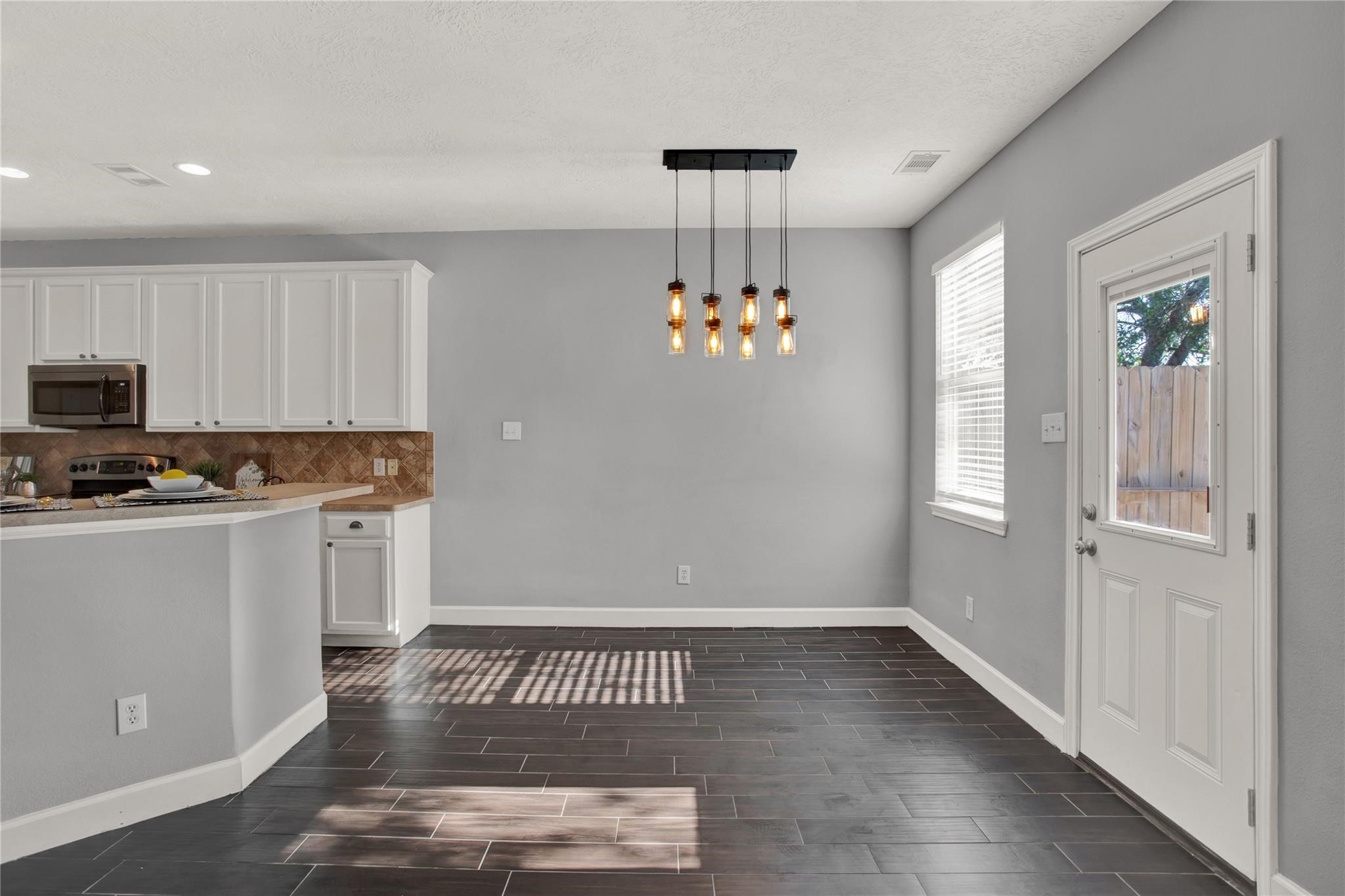 326 Brandy Ridge Lane Dickinson, TX 77539 - Photo 10 of 22 a view of kitchen with a sink wooden cabinets and chandelier