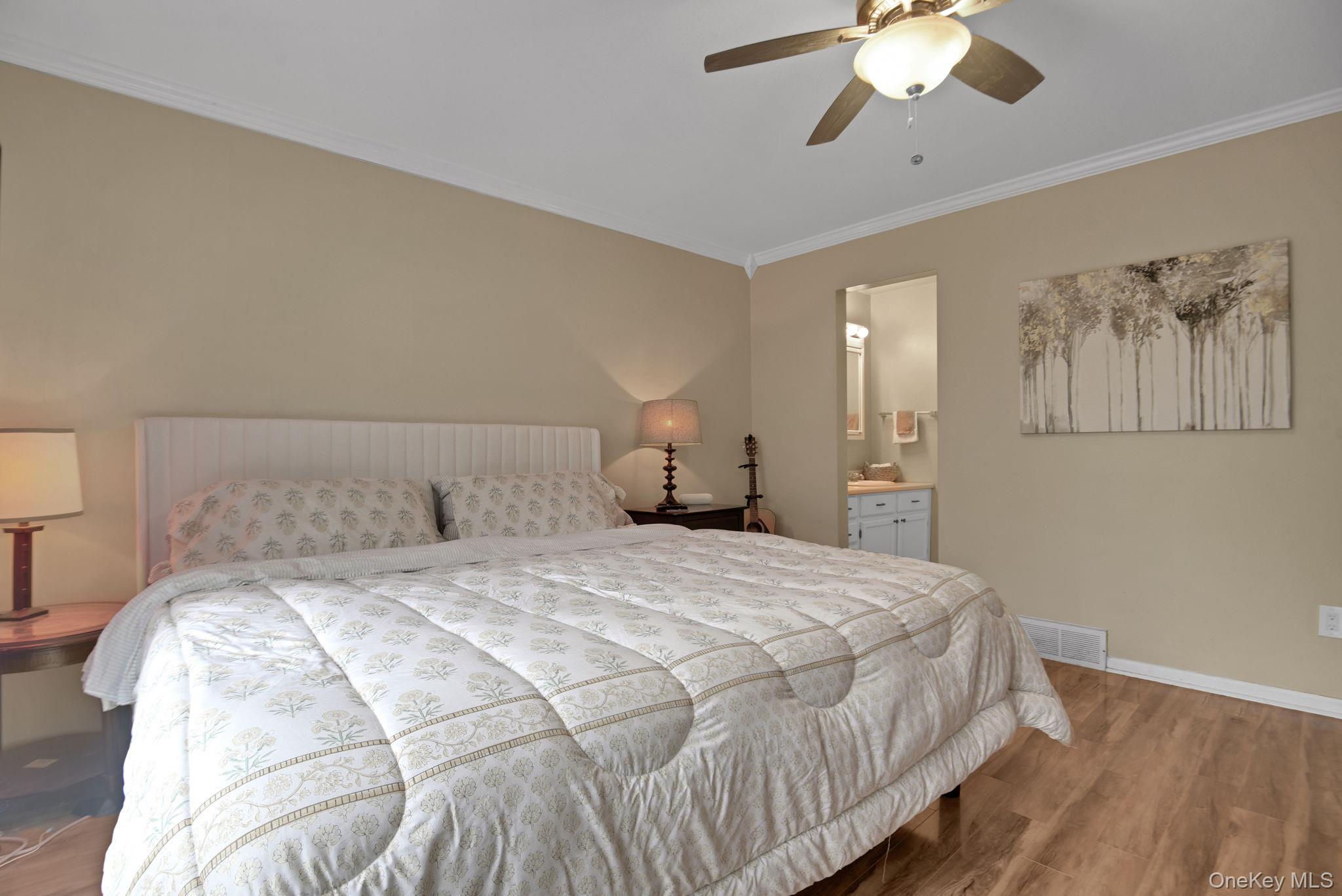805 Eagles Ridge Road Brewster, NY 10509 - Photo 15 of 22 a bedroom with a bed and a chandelier