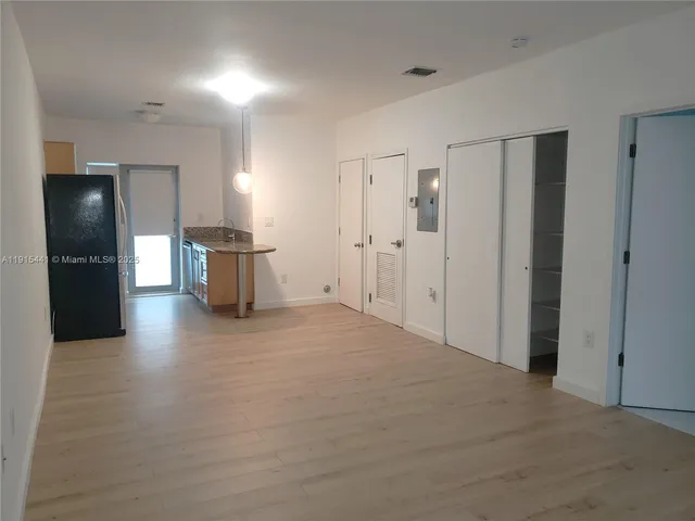a view of a refrigerator in kitchen and furniture