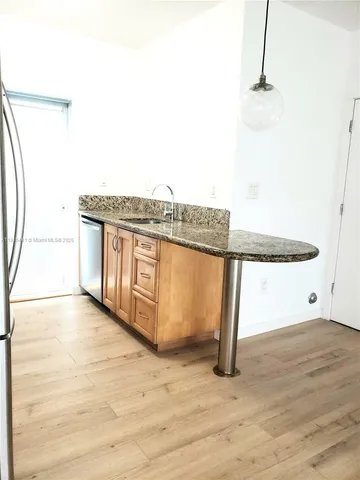 a view of a room with wooden floor and cabinet