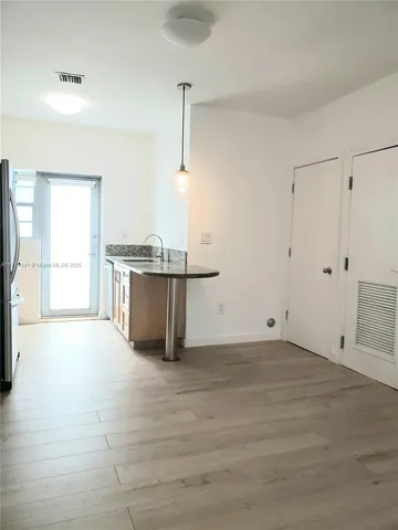 a view of a kitchen with furniture and a window