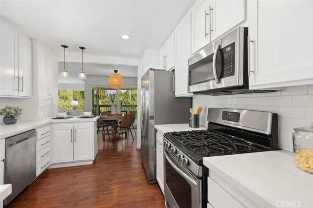 a view of a dining room with furniture wooden floor and a floor to ceiling window