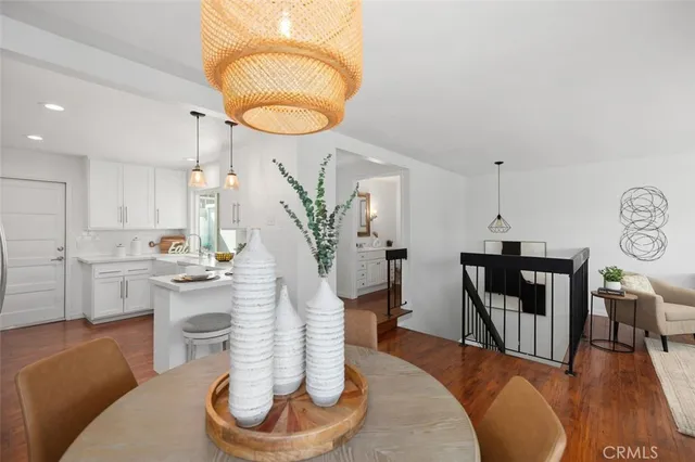 a bedroom with a bed and painting on the wall