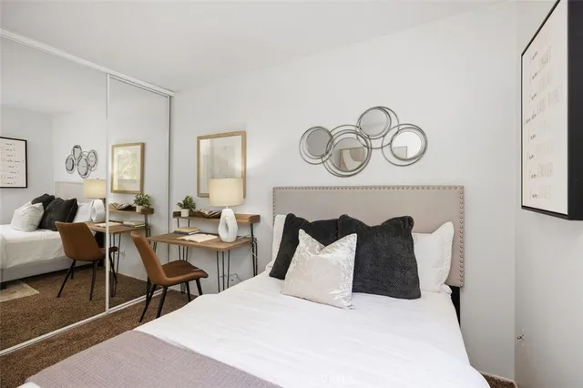 a bedroom with a bed and a large window