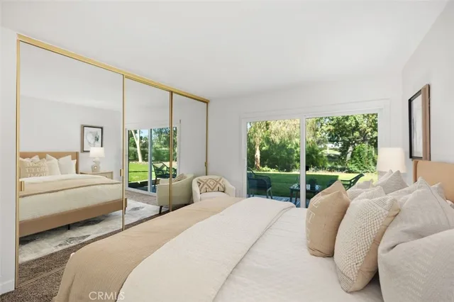 a view of a hallway with wooden floor and dining room