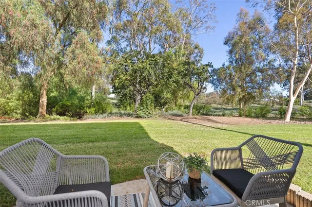 a view of a balcony with chairs and wooden floor