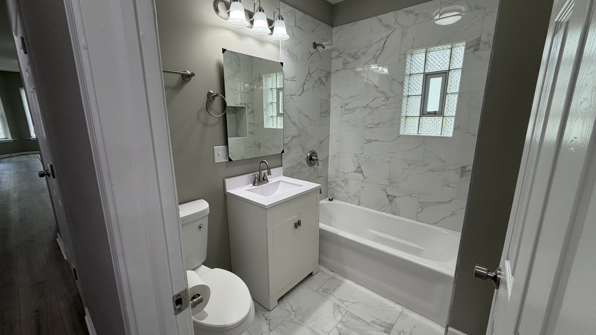 5344 South Aberdeen Street, Unit 1 Chicago, IL 60609 - Photo 11 of 17 a bathroom with a sink a toilet and shower