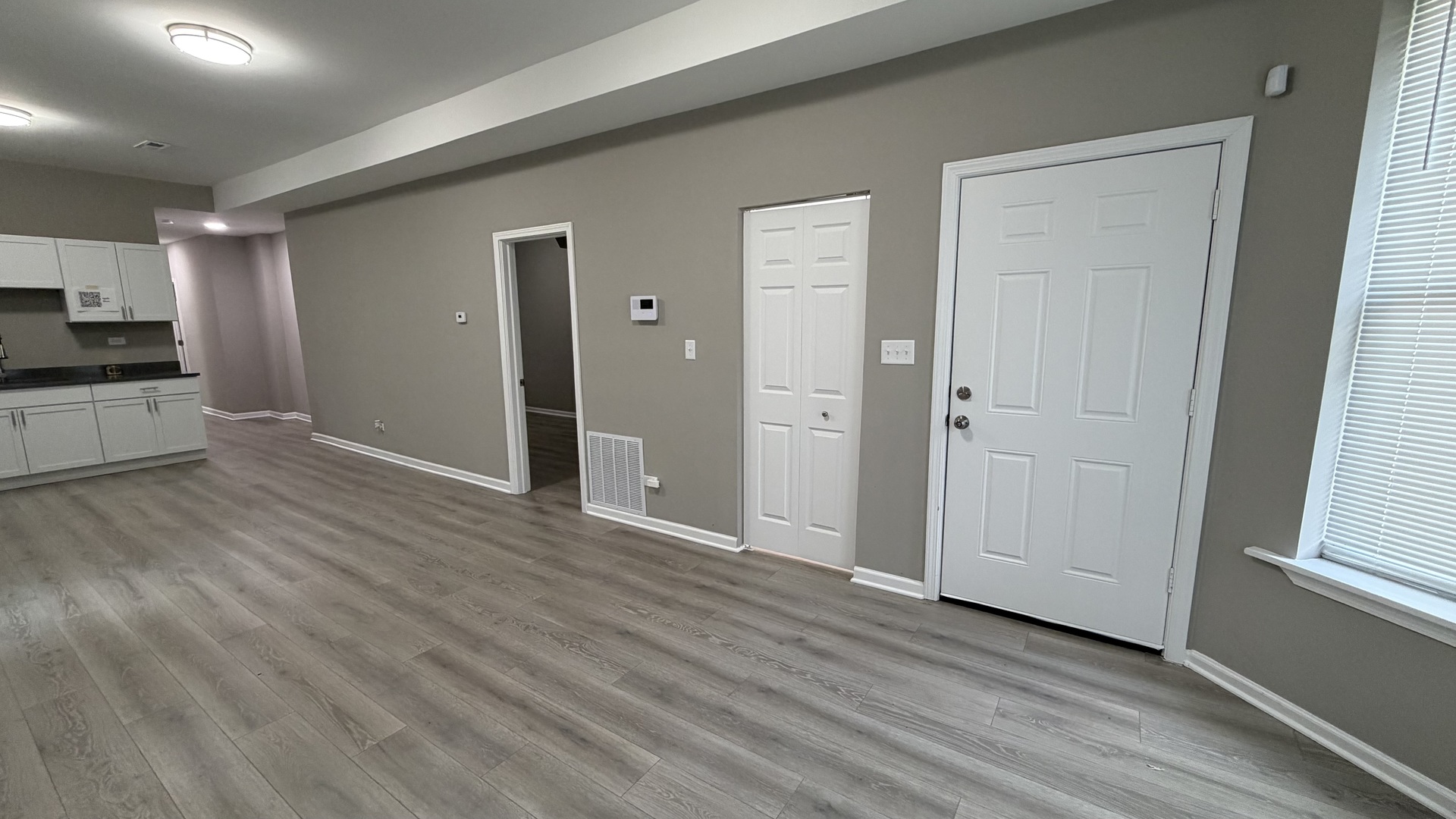 5344 South Aberdeen Street, Unit 1 Chicago, IL 60609 - Photo 4 of 17 an empty room with wooden floor and a window