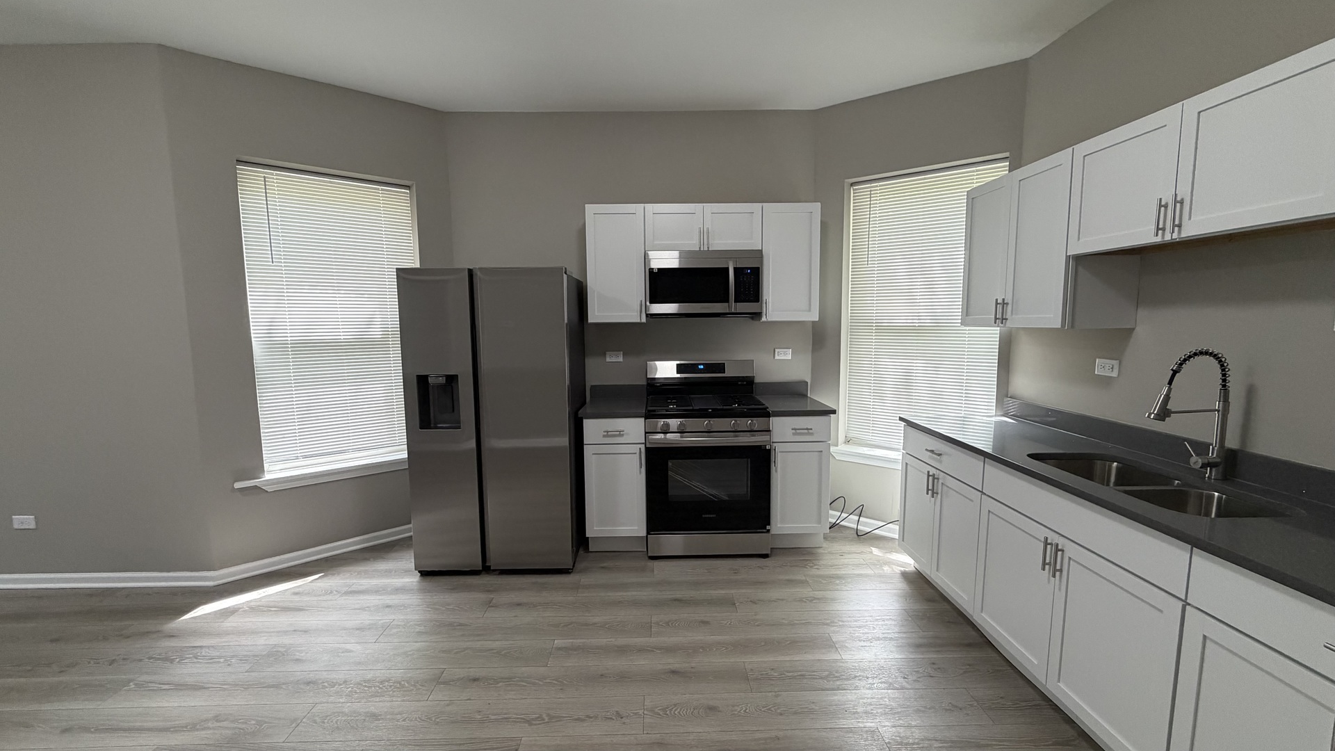 5344 South Aberdeen Street, Unit 1 Chicago, IL 60609 - Photo 7 of 17 a kitchen with stainless steel appliances granite countertop a refrigerator and a stove top oven