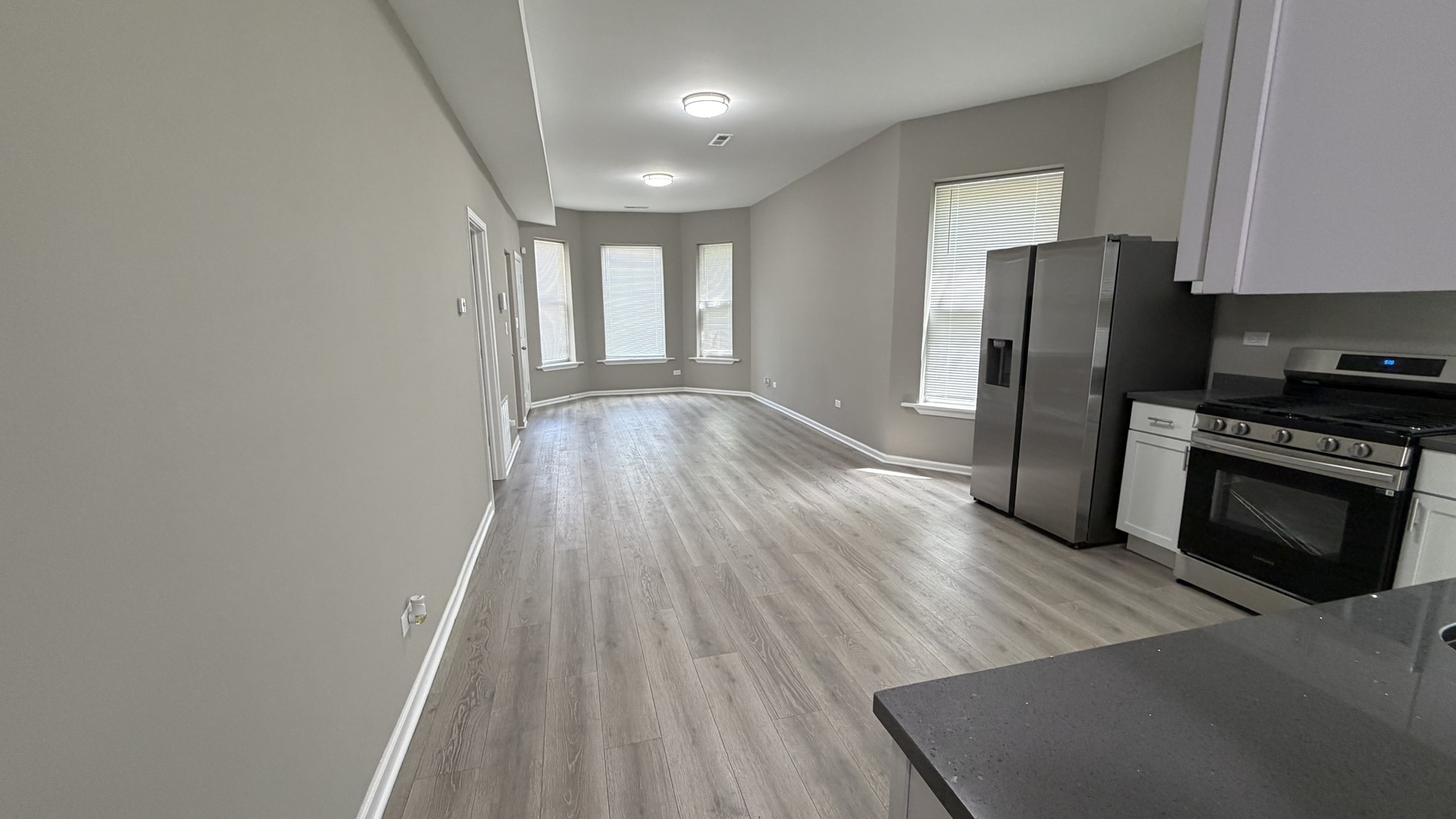 5344 South Aberdeen Street, Unit 1 Chicago, IL 60609 - Photo 8 of 17 a kitchen with wooden floors and black appliances