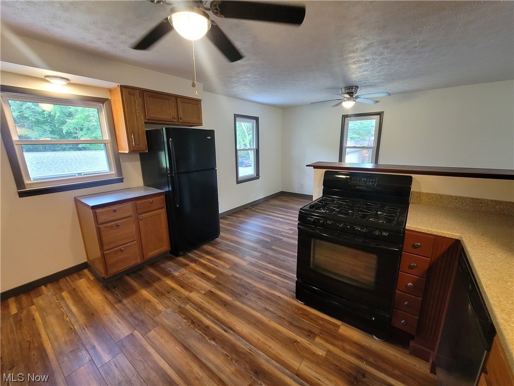 4166 Sherman Road Kent, OH 44240 - Photo 3 of 33 Kitchen with ceiling fan, dark hardwood flooring, black appliances, and countertops light