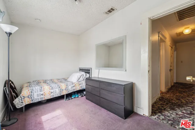 a bedroom with a bed and a cabinets