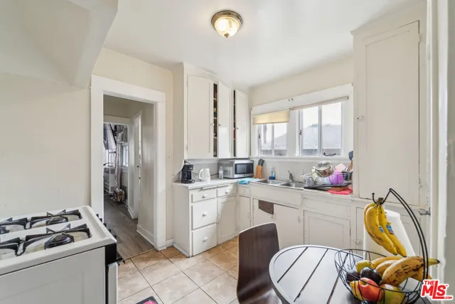 a kitchen that has a sink and a stove